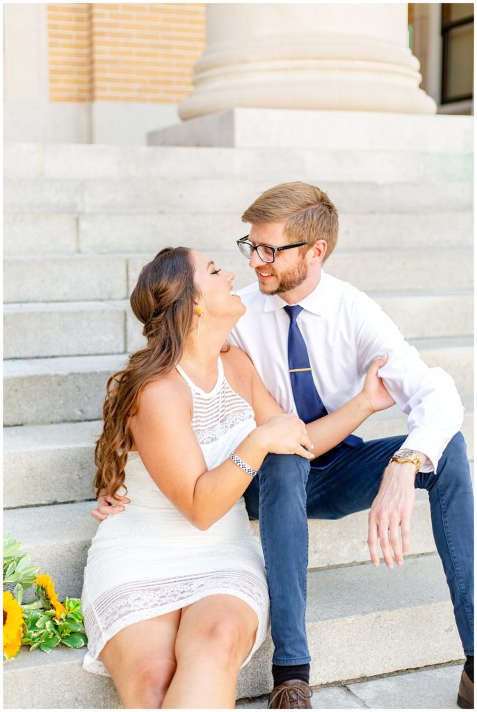 Loving moment between bride and groom on steps in the Tampa Bay area
