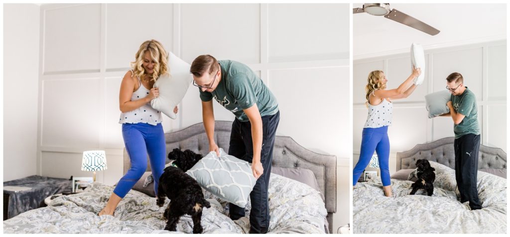 Both Photos of DIY couple standing on a bed with their black dog having a pillow fight in a white bedroom