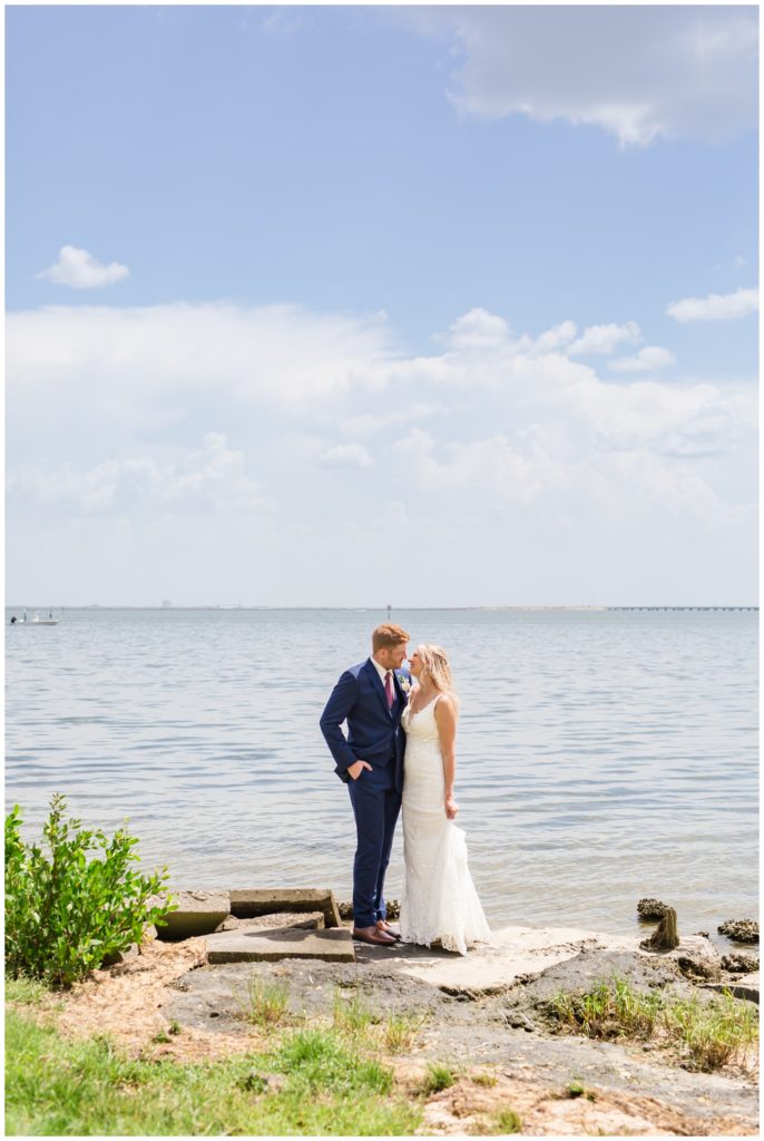 Bride and Groom going in for a kiss near the water in Tampa Florida