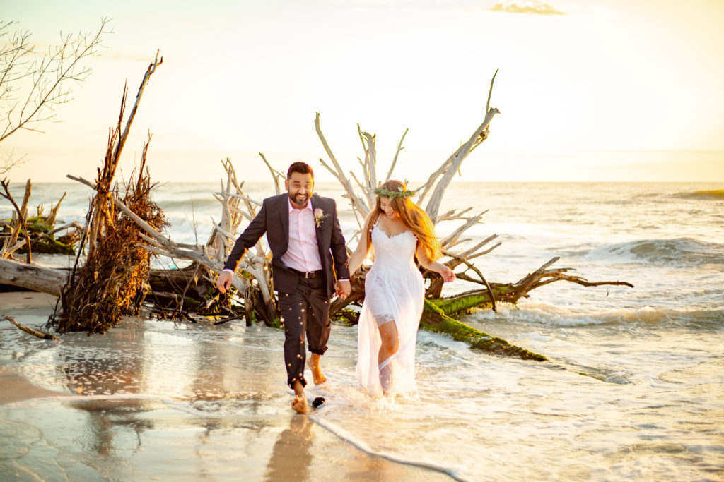 Destination wedding at sunset in Florida beach wedding bride and groom running