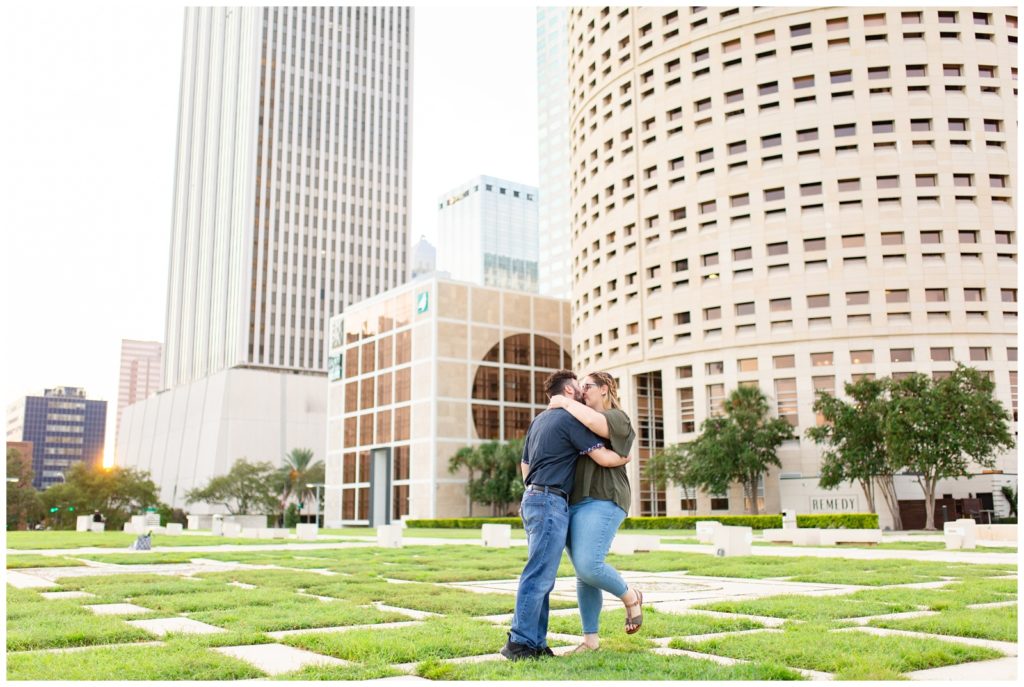 Engaged couple kissing at Kiley Gardens near Tampa Riverwalk at Curtis Hixon Park. 