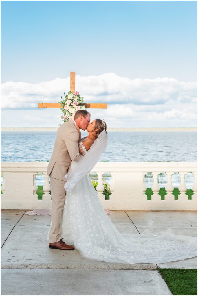 Bride and groom sharing first kiss after ceremony at Bella Cosa wedding venue in Lake Wales Florida